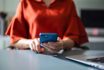 Business professional using smartphone for digital communication, apps, and online connection.