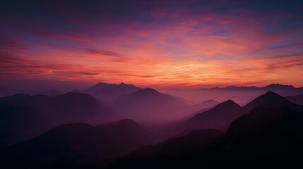 Naklejka premium Layered mountain silhouettes glow under a dramatic twilight sky.