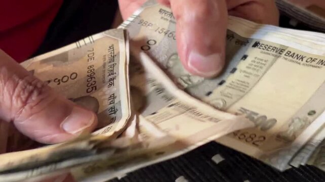 Counting Indian 500 rupees notes