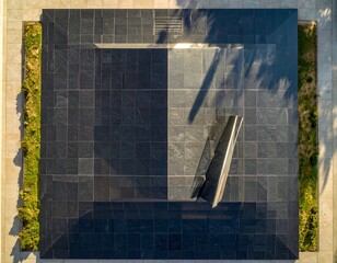 Architectural Abstraction: An elevated perspective of a modern architectural structure showcasing geometric precision, dramatic shadows, and minimalist design.