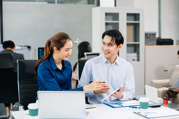 Asian business team collaborating in a modern office, showcasing teamwork, success, and innovation in corporate workplace settings.