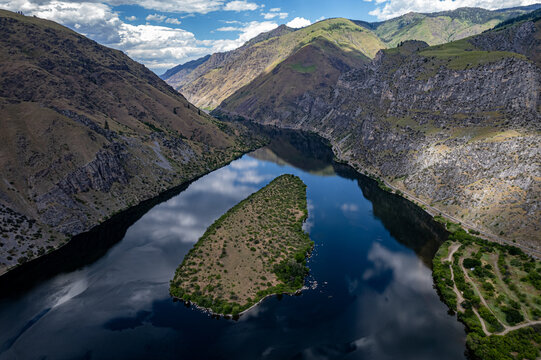 Drone photo of calm surface of Snake river, Hells Cayon. Clouds reflection in blue water