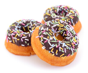Chocolate donuts with colorful sprinkles isolated on white background