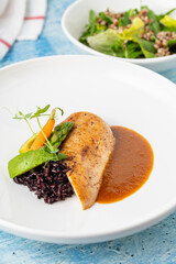 Grilled chicken fillet with black rice and vegetables in sauce