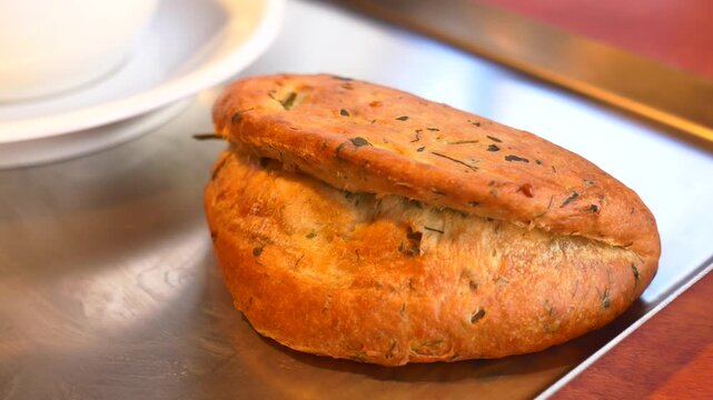 Freshly baked herb bread on a serving tray