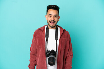 Young photographer caucasian man isolated on blue background with surprise facial expression