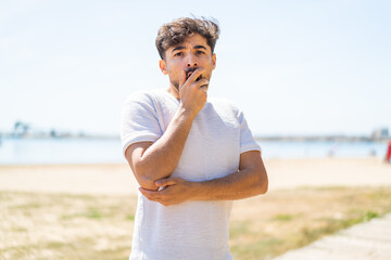 Handsome Arab man at outdoors surprised and shocked while looking right