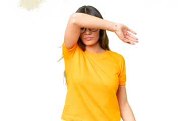 Young caucasian woman over isolated chroma key background covering eyes by hands