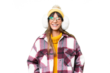 Young caucasian woman wearing winter muffs over isolated chroma key background laughing
