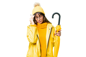Young caucasian woman with rainproof coat and umbrella over isolated chroma key background with headache