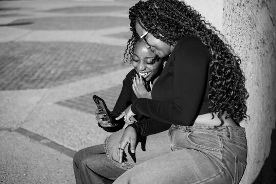 Two young women looking at a phone
