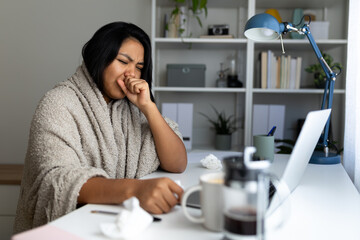 Sick latina woman coughing at home office desk