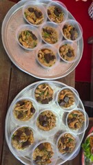 Assorted Delicious Desserts in Transparent Cups on a Serving Tray at a Festive Market Setting