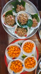 Traditional Thai Dessert Spread with Colorful Treats and Herbal Ingredients on Silver Tray
