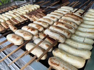 Grilled Bananas are skewered and grilled over a charcoal flame.