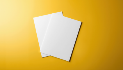 Transparent two blank white sheets of paper overlapping each other, placed on a bright, textured yellow background with dramatic lighting mockup
