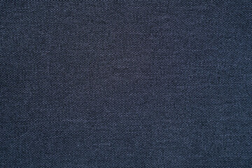 Clothing fabric black microfiber texture background, close up of cloth textile surface abstract.