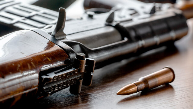 Kalashnikov assault rifle on a wooden table