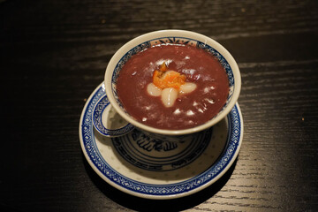 Blue and White Porcelain Bowl with Red Bean Soup on Restaurant Table