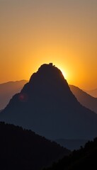 Dahong Mountain silhouette against a sunset sky in Suizhou, China, with buildings crowning the peak and the sun low on the horizon.