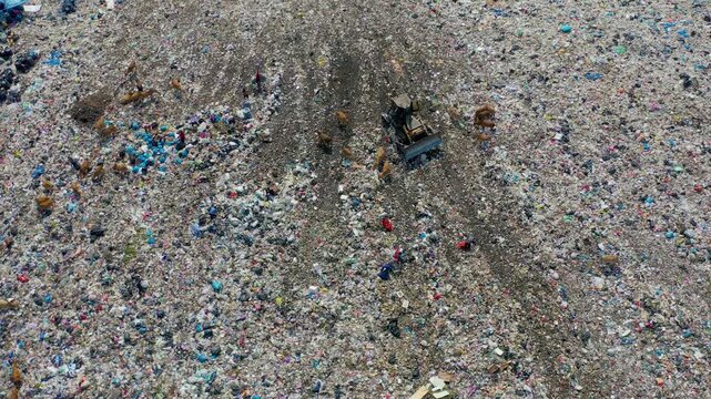 Aerial 4K Drone Half-Circle Rotate Over Massive Landfill and Waste Pickers