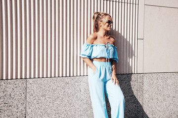 Young beautiful smiling hipster woman in trendy summer clothes. Sexy carefree woman posing on the...