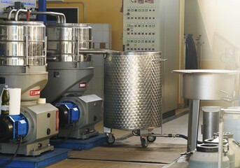 Olive processing line. Freshly picked olives are processed in a modern oil mill. Green and purple olives are fed onto a conveyor for cleaning and pressing.