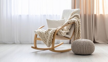 Cozy living space featuring a rocking chair, knitted blanket, and pouf beside a window