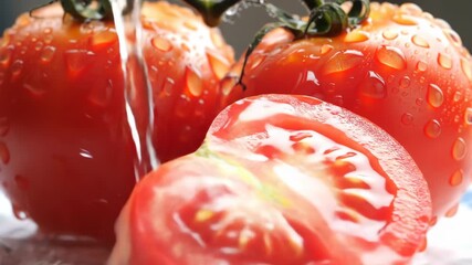 Close-up of wet, ripe tomatoes, one sliced open, on a light background. For food, health, or fresh produce concepts - Powered by Adobe