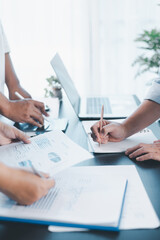 Business teamwork reviewing financial report with charts and graphs in modern office, colleagues discussing analysis, planning strategy, growth and corporate success with documents and technology.