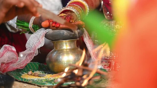 Hands of the bride and groom in wedding Ceremony. Hindu wedding ritual. Odia Wedding. Hindu Wedding Ceremony with Burning Fire and Offering Ritual with People and Golden Details.