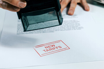 Document stamped with New Tariffs -  business and trade regulation concept