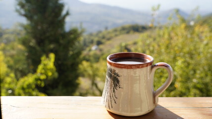 Morning Coffee on a Wooden Balcony with a Scenic View