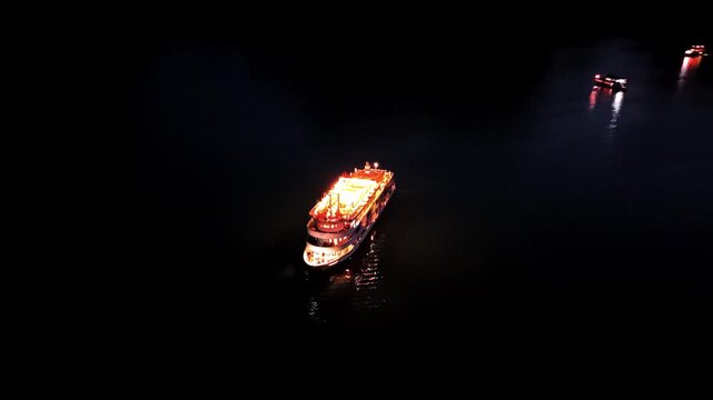 Halong Bay (Ha Long Bay) Vietnam filmed at night with a drone following a cruise ship