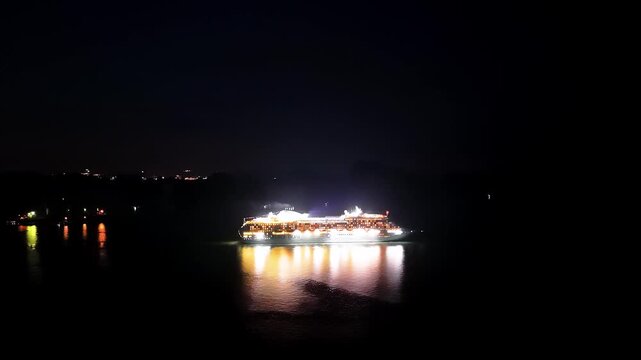 Halong Bay (Ha Long Bay) Vietnam filmed at night with a drone following a cruise ship