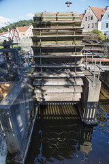 Old wooden water wheel and metal sluice gate at a historic hydroelectric station