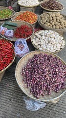 Colorful Baskets of Fresh Vegetables and Bulbs at Market Stall
