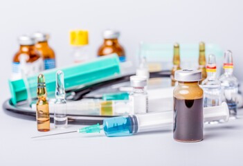 Medical vial with medication and syringe close up