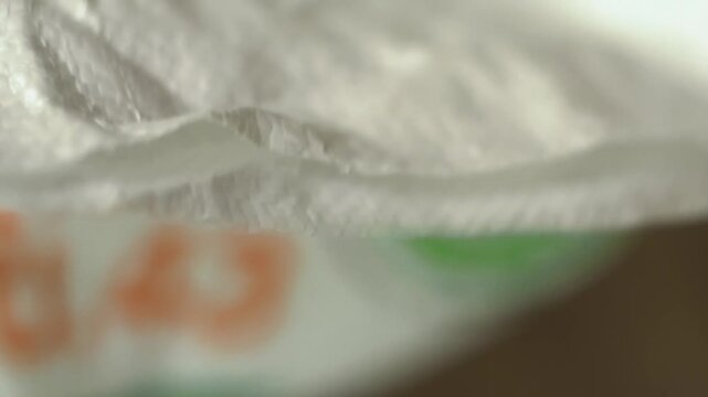 Close up of hand open bag of Milk stage rice or Young rice milk is a powerhouse of fiber, B vitamins, and essential minerals. It's easily digestible, subtly sweet, and packed with health benefits.