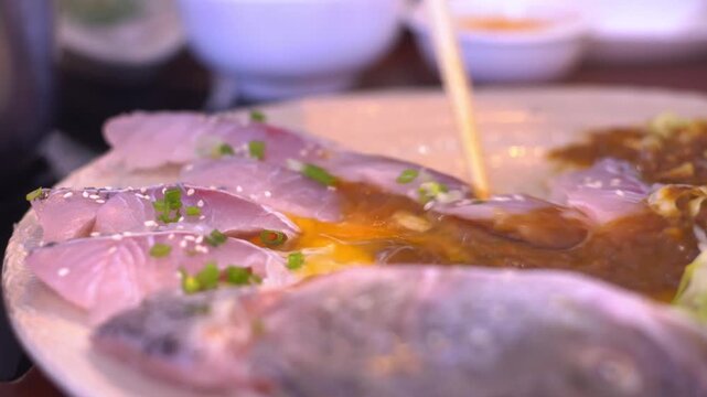 Fresh Barramundi slices, ready for a delicious shabu-shabu or sukiyaki feast. Love Seafood HotPot. Healthy food at restaurant.