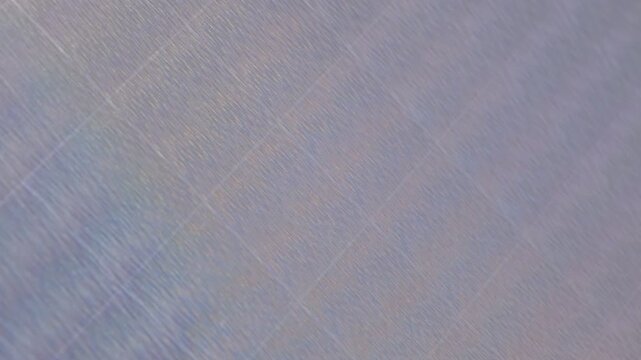 iridescent surface displaying a mesmerizing pattern of tiny, shimmering dots, organic pattern. The texture appears slightly raised, creating a ripple effect both abstract and vibrant