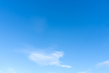 Low angle view and full frame of beautiful light blue sky with strange shape of fluffy thin white clouds in the afternoon on sunny day used as natural background texture in decorative art work