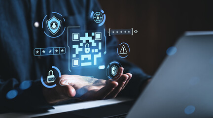 Cybersecurity concept with digital QR code and secure login icons floating over hands in dark...