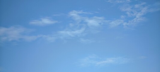 sky is blue and clear with clouds. The sun is shining brightly