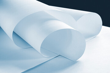 Long sheets of paper from a roll of blue tone.