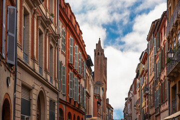 Rue du Taur, and the bell tower wall of the Church of Taur, in Toulouse, Haute Garonne, Occitanie, France.