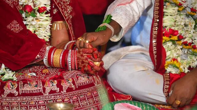 Hands of the bride and groom in wedding Ceremony. Hindu wedding ritual. Odia Wedding. Hindu Wedding Ceremony with Burning Fire and Offering Ritual with People and Golden Details.