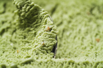 Close-up pistachio ice cream background scooping