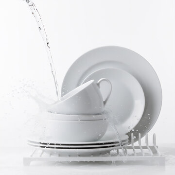 Dishes white bowl and plates and spoon on the table