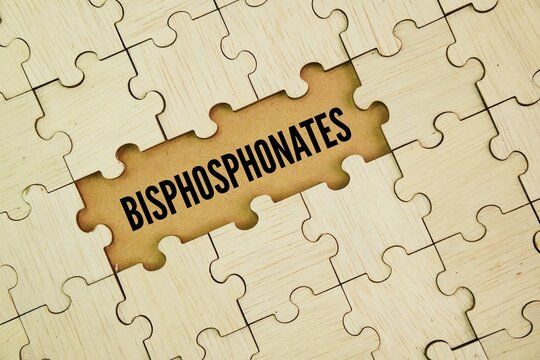 Wooden puzzle with the word bisphosphonate. a class of drugs used to prevent bone density loss and treat conditions like osteoporosis and Paget's disease by slowing down the breakdown of bone